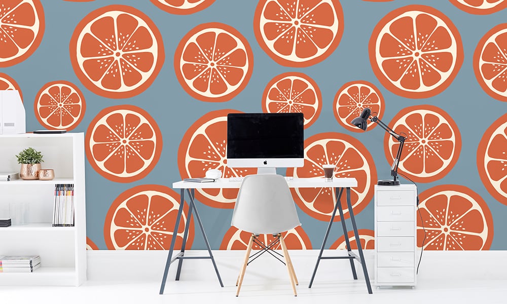 Sliced orange wallpaper design in large scale with desk and chair
