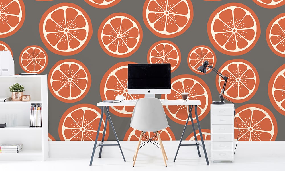 Sliced orange and grey wallpaper design in large scale with desk and chair