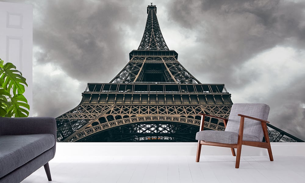 Eiffel tower wall mural in a living room with grey sofa