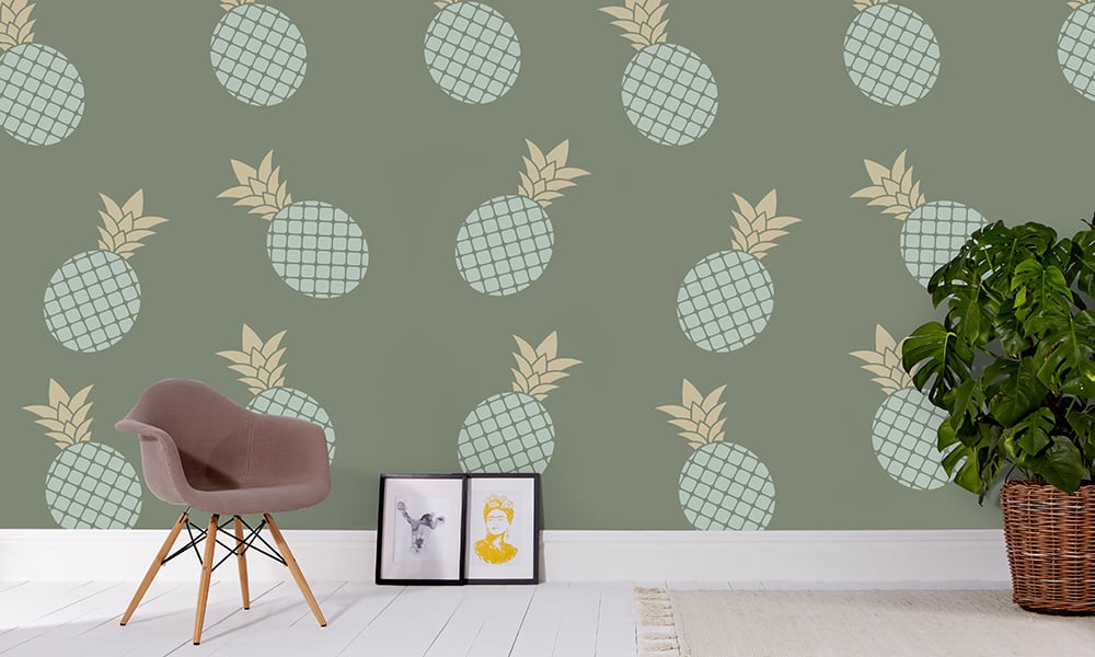 Green pineapple wallpaper in large scale with grey chair and frame