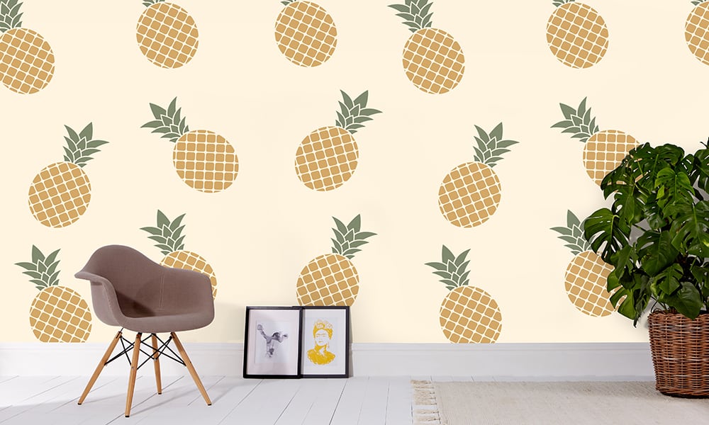 Yellow pineapple wallpaper in large scale with grey chair and frame