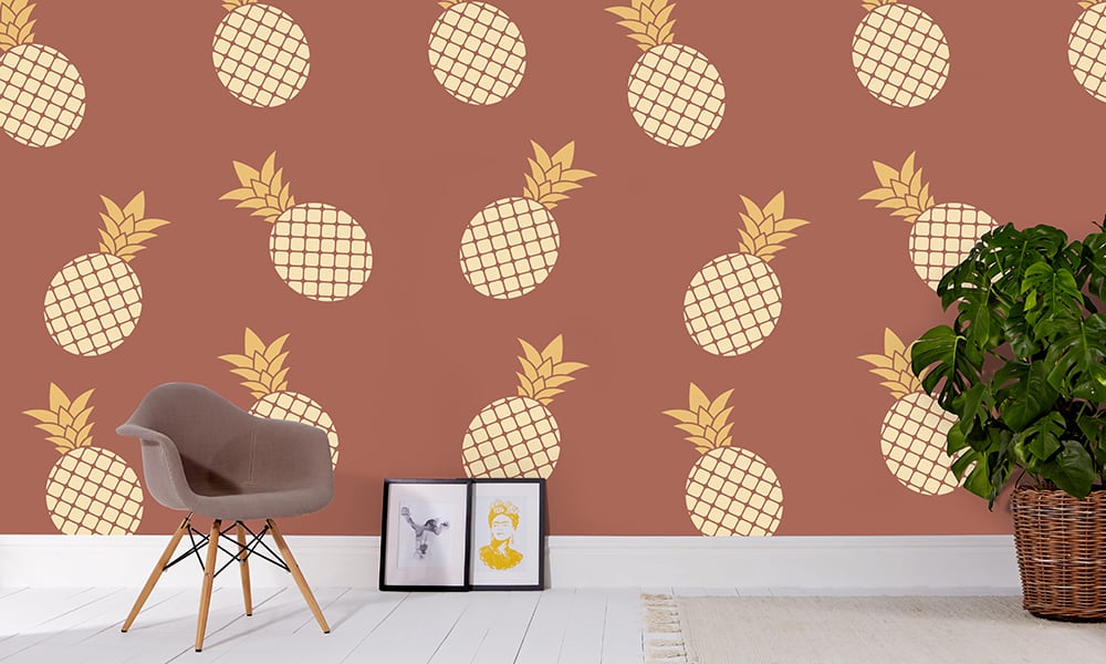 Red pineapple wallpaper in large scale with grey chair and frame