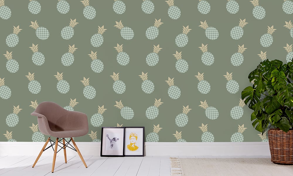 Medium scale pineapple wallpaper in sage situated in living area