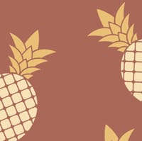 Pineapple wallpaper design in jupiter red with grey chair and picture frame