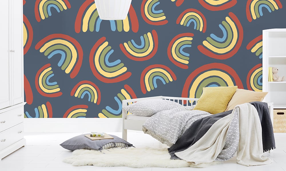 Large scale rainbow wallpaper design situated in kids bedroom