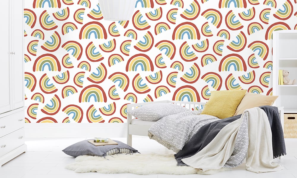 Medium scale rainbows against white background wallpaper in kids bedroom