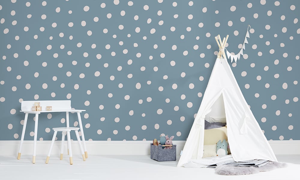 Blue polka dot wallpaper in a medium size situated in kids bedroom