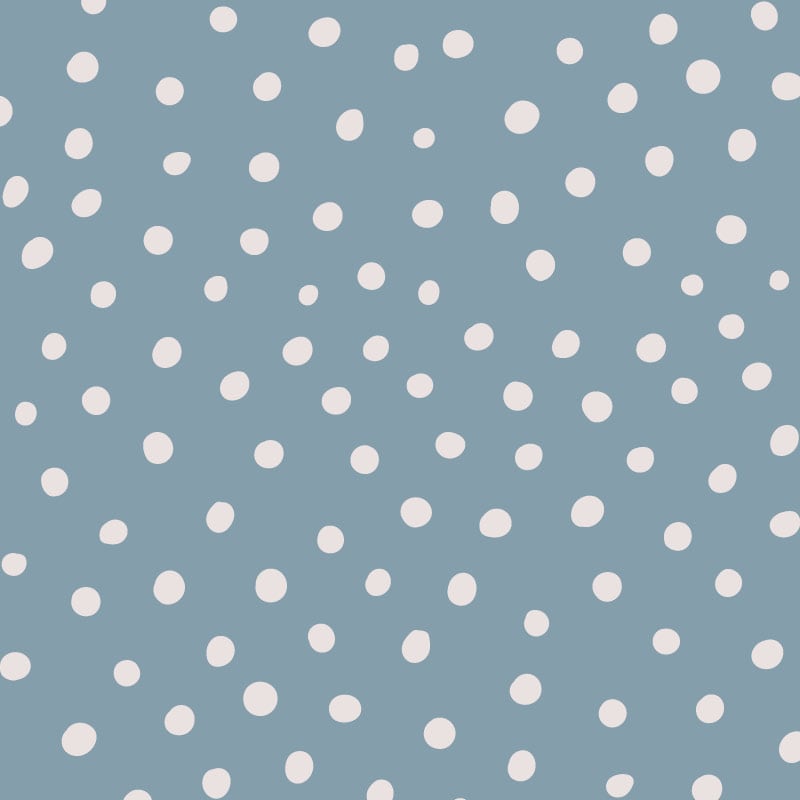Inverted blue polka dot wallpaper situated in kids bedroom with a play tent