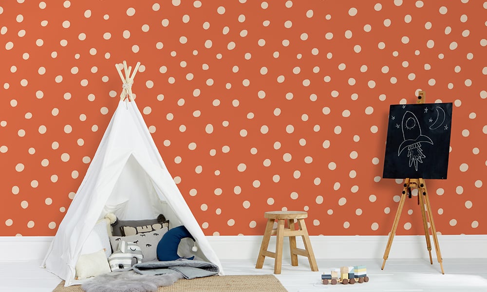 Orange polka dot wallpaper in a medium size situated in kids bedroom