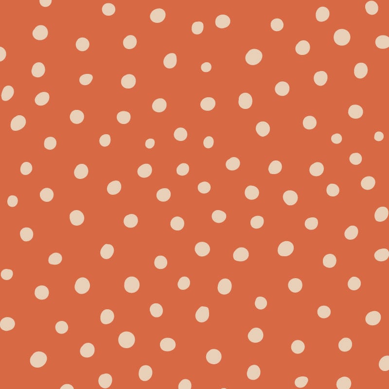 Inverted orange polka dot wallpaper situated in kids bedroom with a play tent