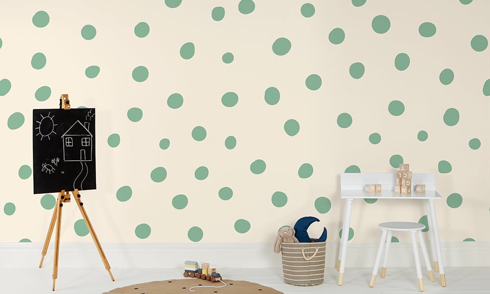Green polka dot wallpaper in a large size in a kids bedroom
