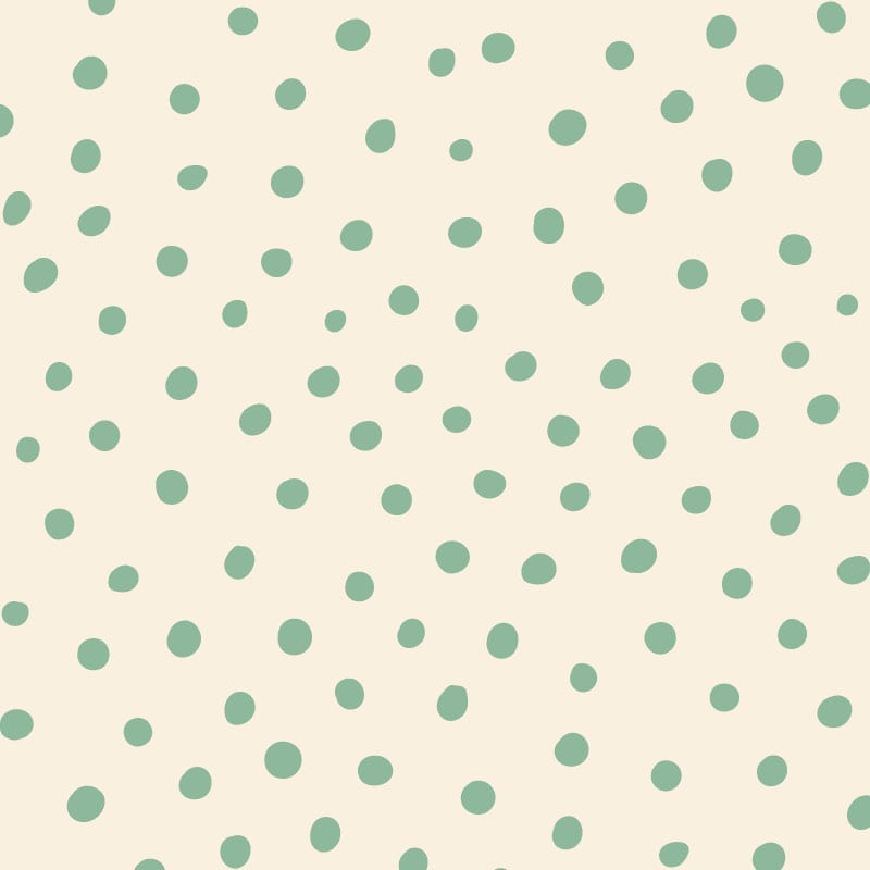 Green polka dot wallpaper situated in kids bedroom with a chalk board