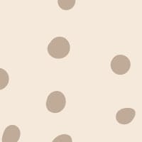 Neutral polka dot wallpaper situated in kids bedroom with a chalk board