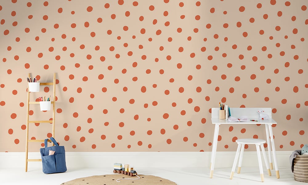 Orange and red polka dot wallpaper in a medium size situated in kids bedroom