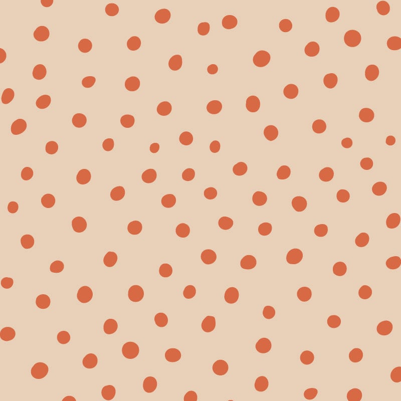 Orange polka dot wallpaper situated in kids bedroom with a ladder
