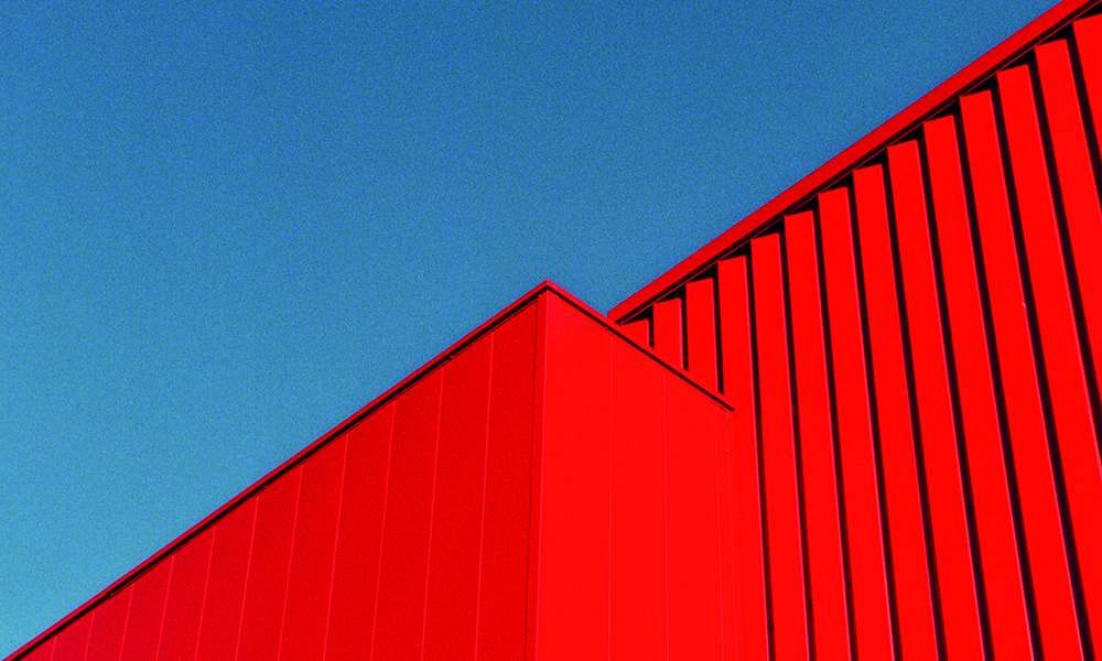 Abstract view of a bold red building with blue sky