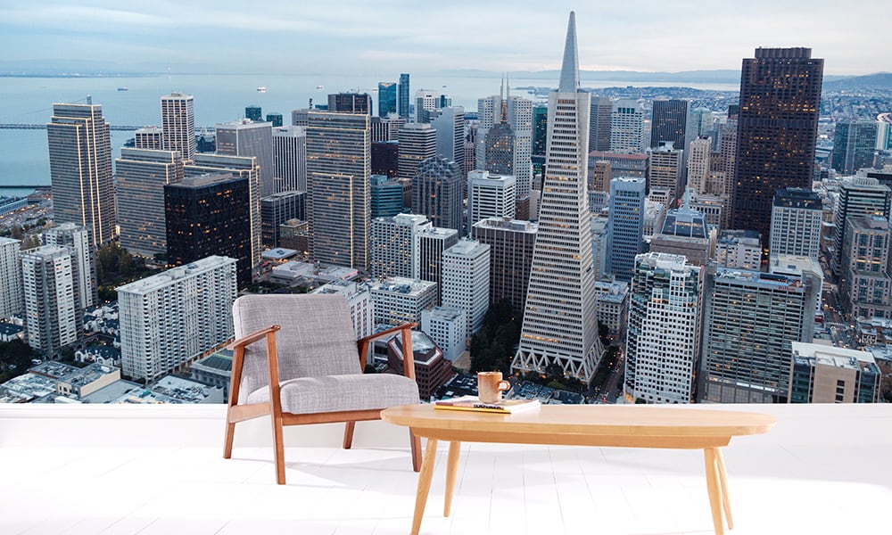 San Francisco cityscape wallpaper mural in a living room with grey chair