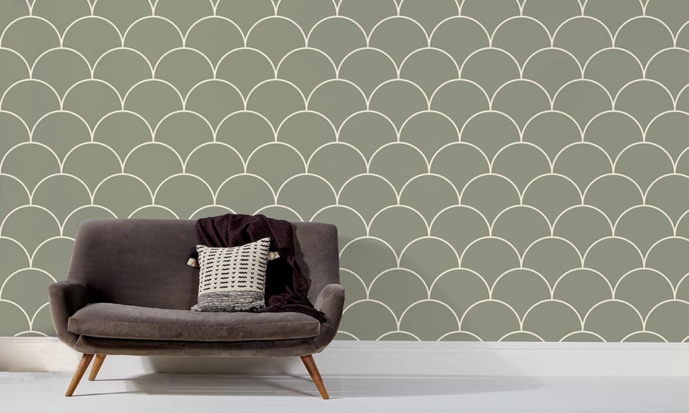 Large scale green wallpaper design in living room with grey sofa and side table