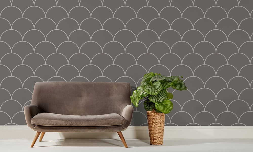 Large scale grey wallpaper design in living room with grey sofa and plant