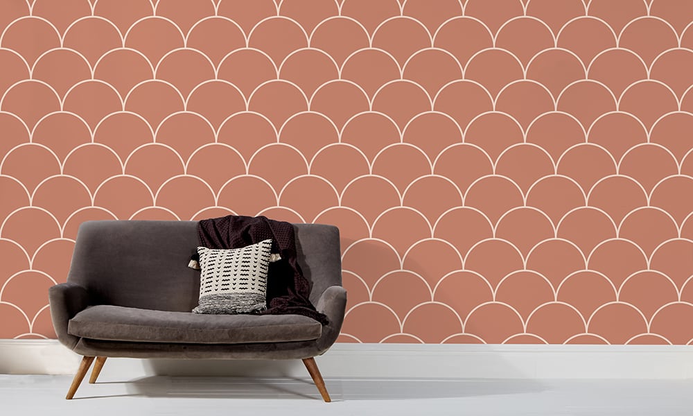 Large scale red wallpaper design in living room with grey sofa and clock