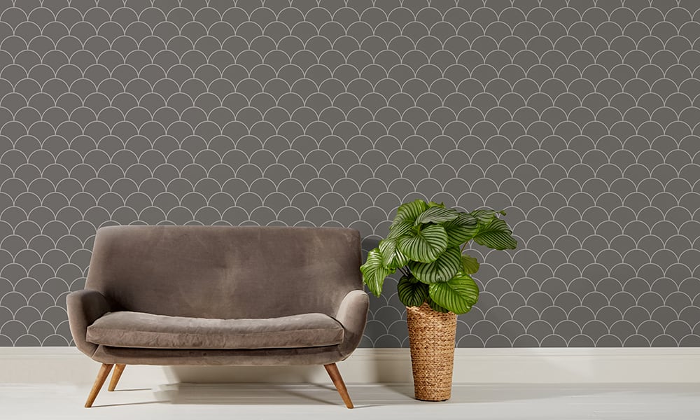 Scales wallpaper design in grey and a medium size with grey sofa and plant