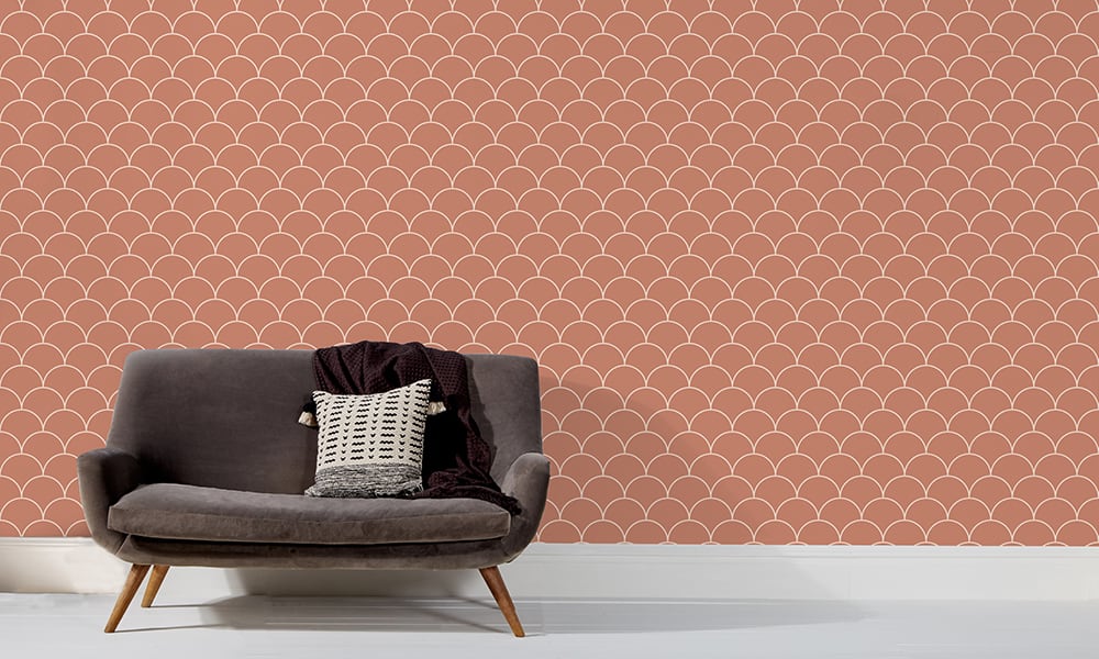 Scales wallpaper design in red earth and a medium size with grey sofa and clock