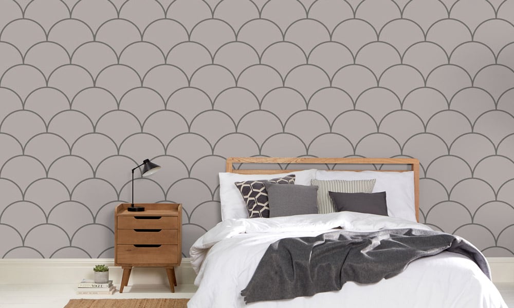 Large scale grey wallpaper design in bedroom with grey bedding and side table