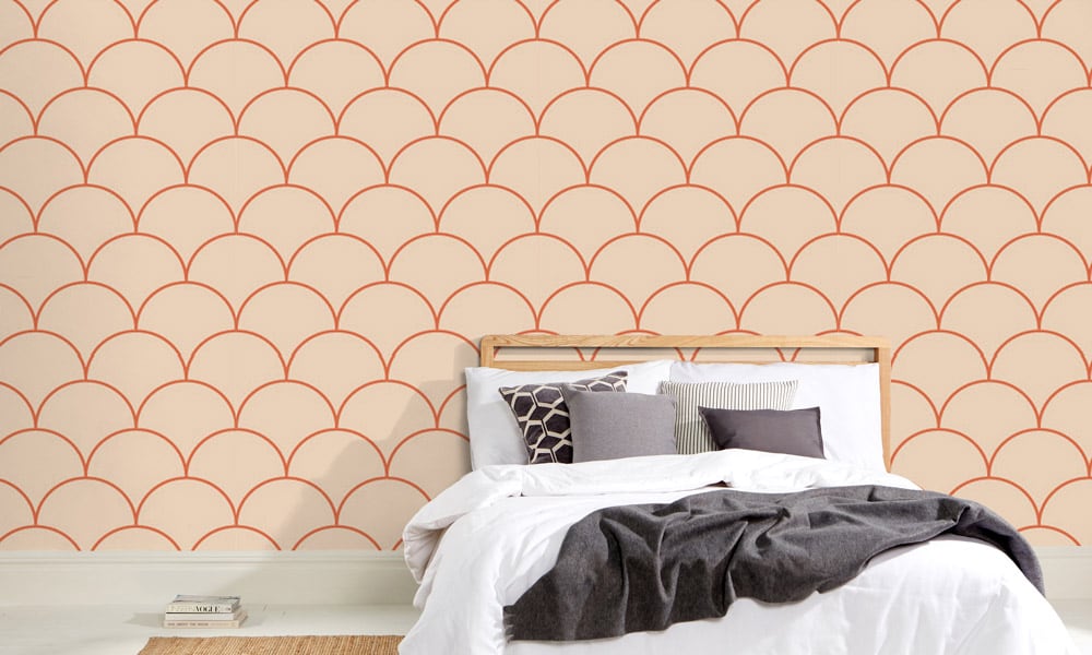 Large scale orange wallpaper design in bedroom with books 
