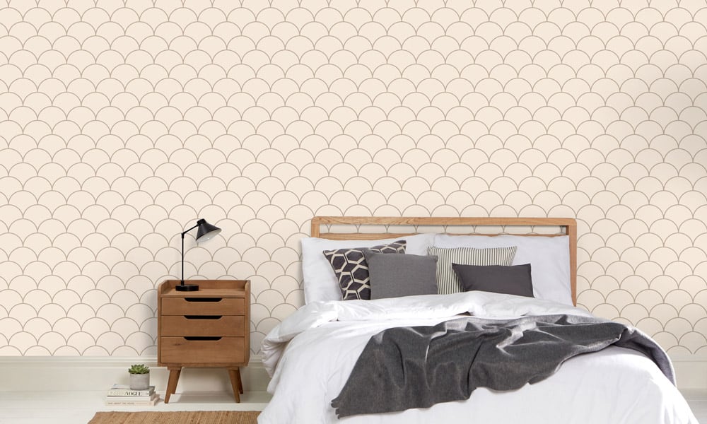 Scales wallpaper design in neutral and a medium size with bedding, side table and lamp