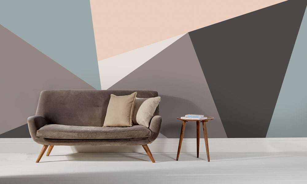 Modern wall mural with sharp lines in grey and pastel colour tones in a mid-century style living room 