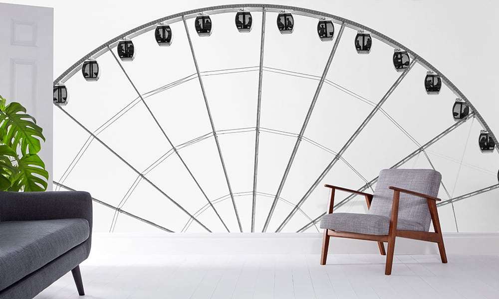 Living room with grey chair and sofa with a ferris wheel wall mural in black and white