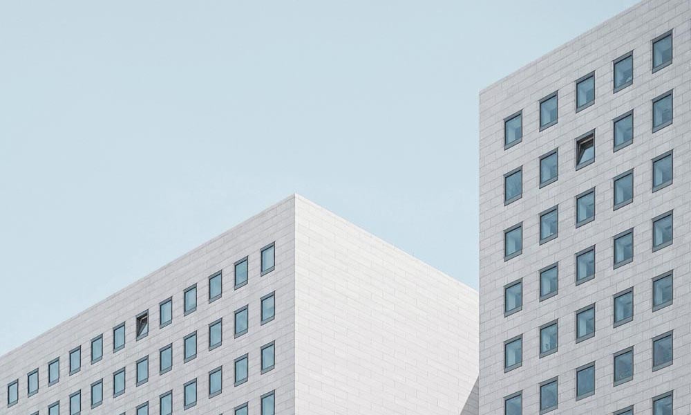 White modern building with square windows and blue sky