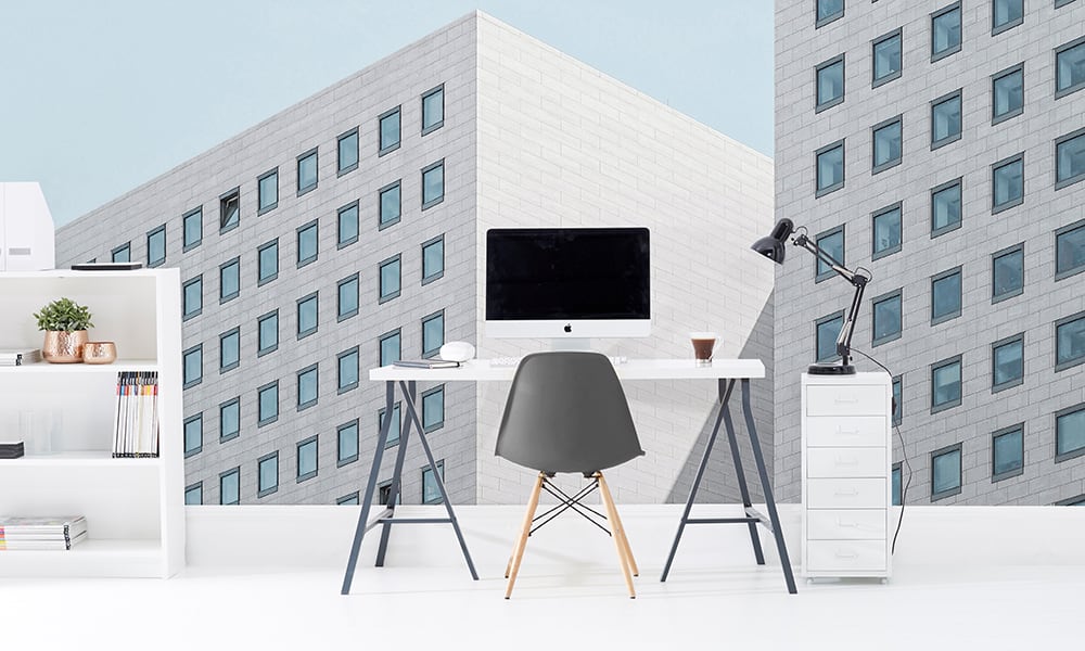 Modern office with an architectural wall mural of a clean white building