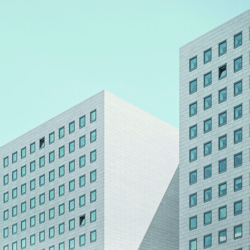 Wall mural of a modern style white building with square windows in a contemporary office setting