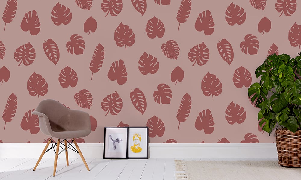 Tropic maroon wallpaper in a large scale with a chair and picture frame