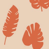 Tropic orange wallpaper pattern in living area with grey chair and frames