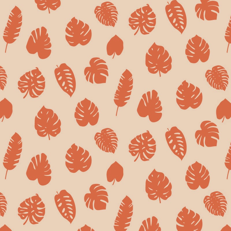 Tropic orange wallpaper pattern in living area with grey chair and frames