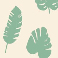 Green leafy patterned wallpaper in living room with grey chair and frames