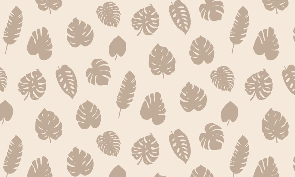 Tropical leaf design wallpaper in a neutral sand colour