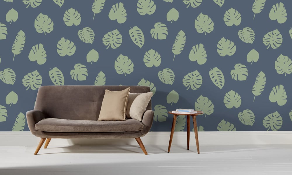 Large scale wallpaper green leaves on blue background