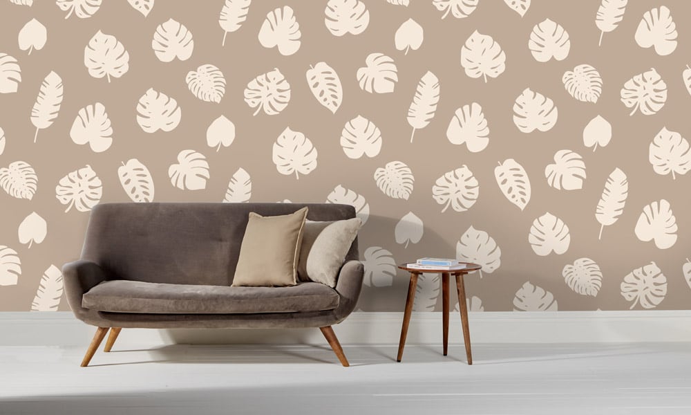Large scale wallpaper neutral leaves with sofa and side table