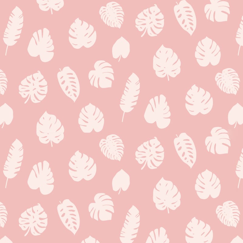 Pink leafy patterned wallpaper in living room with grey sofa and cheese plant