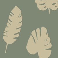 Green leafy patterned wallpaper in living room with grey sofa and side table