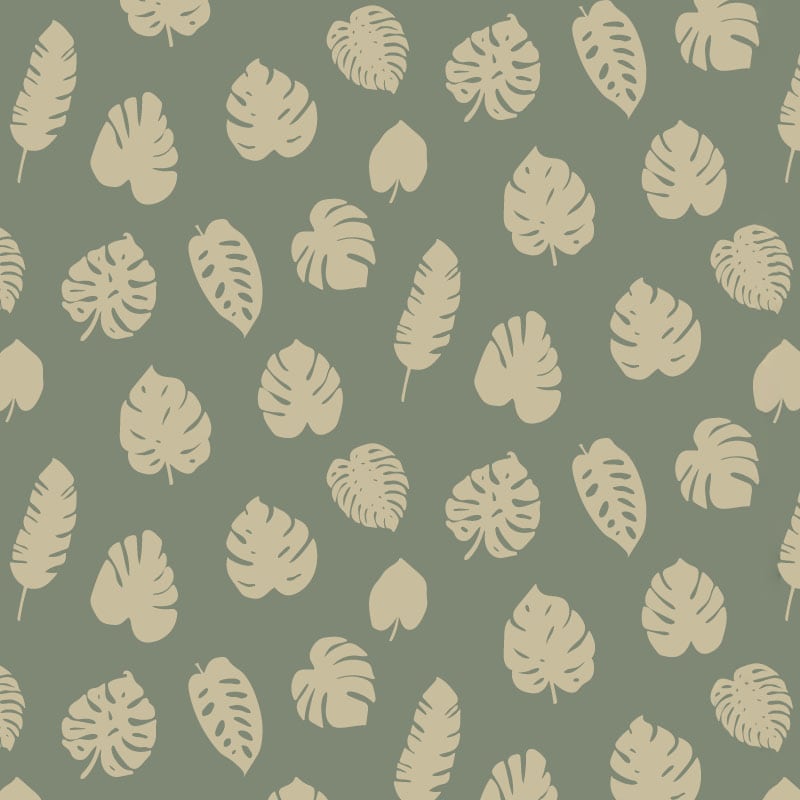 Green leafy patterned wallpaper in living room with grey sofa and side table