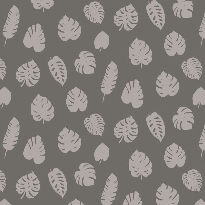 Grey leafy patterned wallpaper in living room with grey sofa and cheese plant