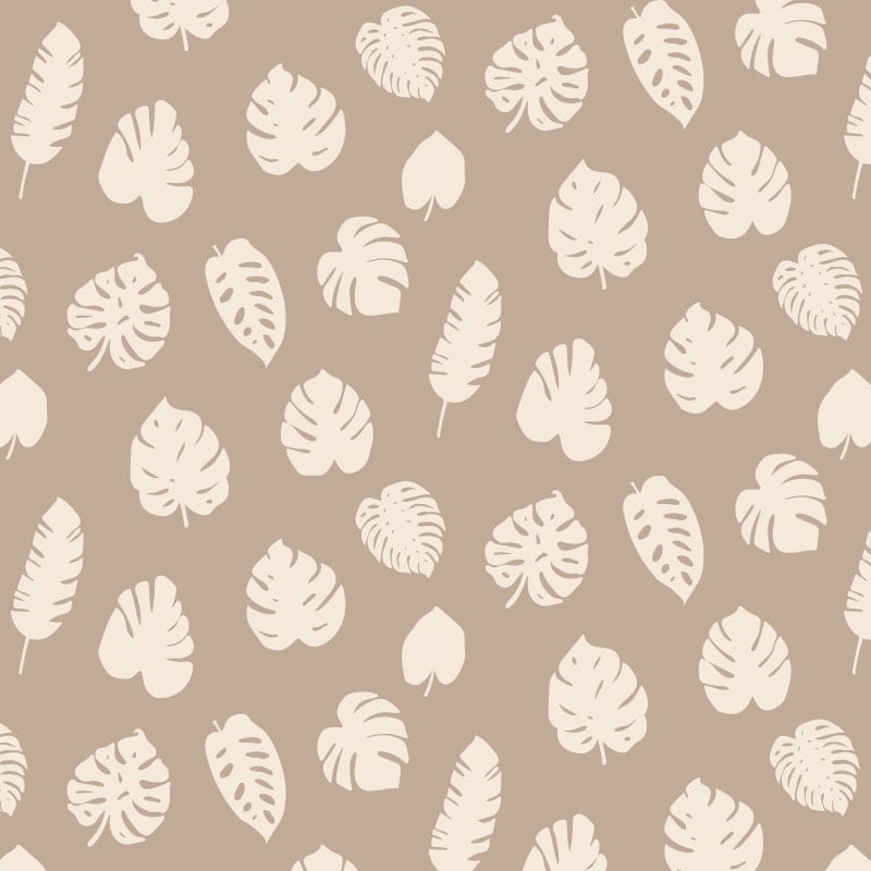 Neutral leafy patterned wallpaper in living room with grey sofa and side table