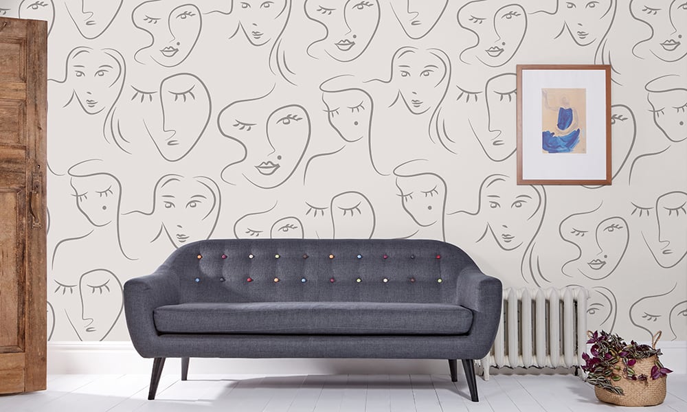 Living room wall covering made up of womans face with beauty spot
