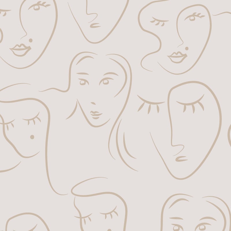 Abstract faces patterned wallpaper situated in living room with a grey sofa