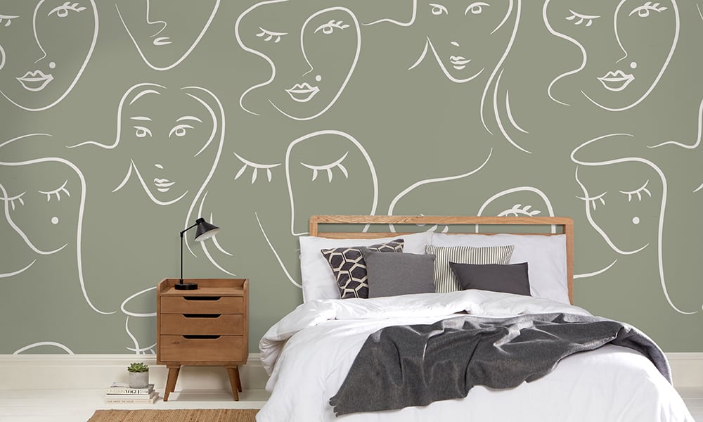 White female faces pattern on green wallpaper in bedroom - large scale