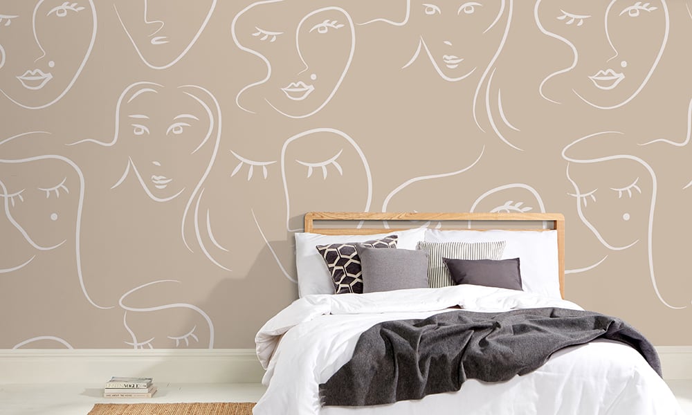 White female faces pattern on neutral wallpaper in bedroom - large scale